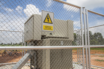 High-voltage device with aluminium fence and sign