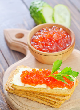 toasts with red caviar on board