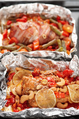 Two cooked dishes in foil