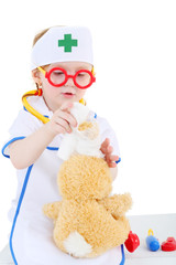 Little girl dressed as nurse and in glasses bandages head to toy