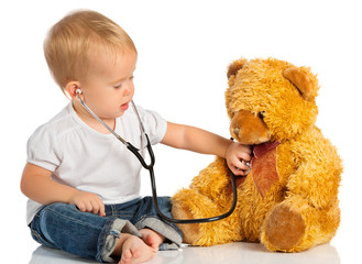 baby plays in doctor toy bear and stethoscope