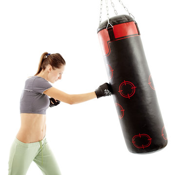 Athletic Woman Hitting The Punching Bag