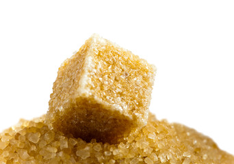 Sugar cube on a heap of granulated sugar