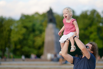 Fototapeta premium Young father holding his little girl