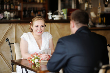 Bride and groom drinking coffee