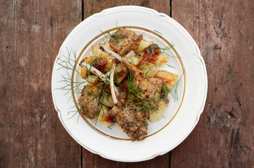 Rack of lamb dish on old wooden table