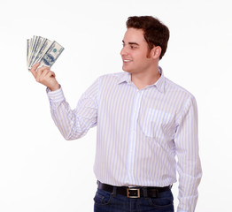Young man standing and holding cash dollars