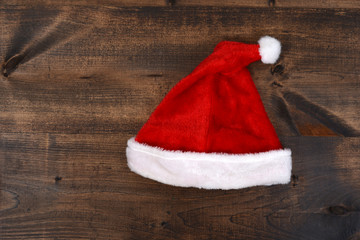 Obraz na płótnie Canvas christmas santa hat on wood