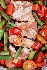 Chicken breast wrapped in bacon prior to baking