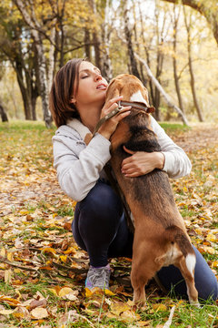 Woman playing with her beagle pet