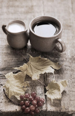 Obraz na płótnie Canvas Artwork in retro style, cup of coffee, milk jug, yellow leaves,