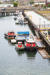 Fototapeta na wymiar Red Tugboats at Pier