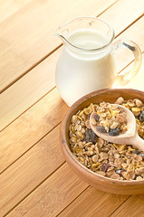 Plate with raw oatmeal on wooden table.