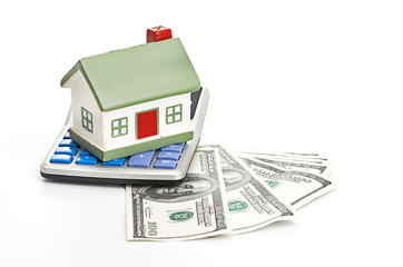 house sitting with a calculator and dollar