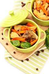 Homemade beef stir fry with vegetables in color pans, isolated
