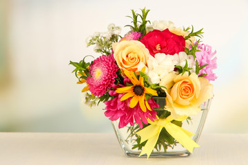 Beautiful bouquet of bright flowers in glass vase,