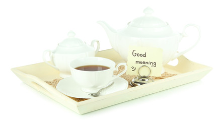 Cup of tea with cakes on wooden tray isolated on white