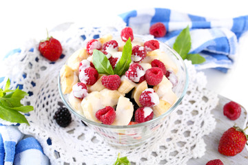 Fruit salad in glass bowl, isolated on white