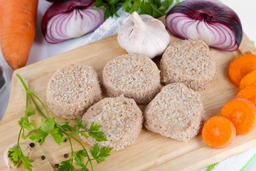 Meat patties on board on napkin close-up