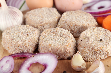 Meat patties on board on napkin close-up