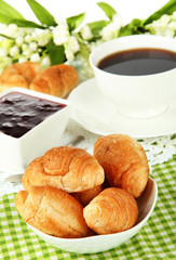 Tasty croissants and cup of coffee close-up