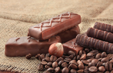 Delicious chocolate bars with nuts and coffee beans