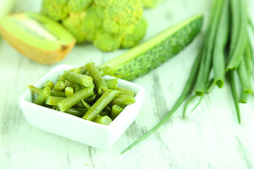 Fresh green vegetables, on wooden background