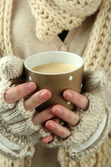 Female hands with hot drink, close-up