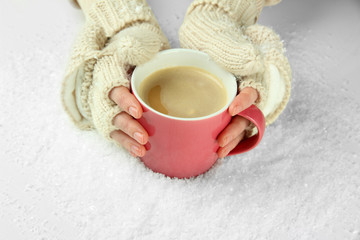 Female hands with hit drink, on light background