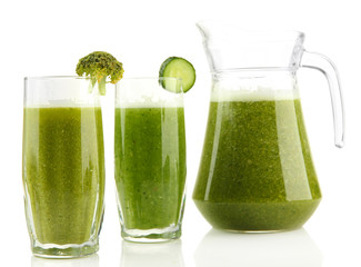 Glasses and jug of green vegetable juice isolated on white