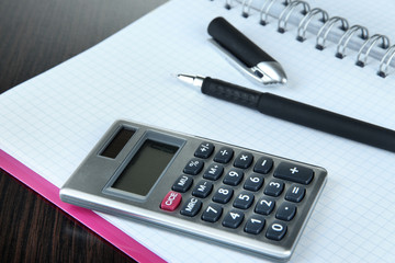 Notebook with pen and calculator close up