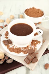 Fotobehang Cocoa powder in cup on napkin on wooden table © Africa Studio