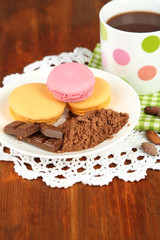Cocoa in cup with sweets and cocoa powder