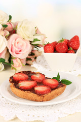Delicious toast with strawberry on table on light background