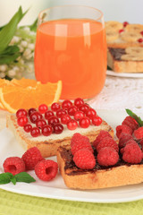 Delicious toast with berries on table on light background