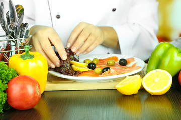 Cook hands decorating dish