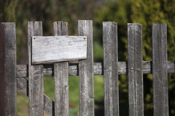 Wooden fence with empty sign board