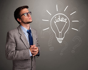 Young boy comming up with a light bulb idea sign