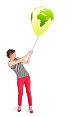 Happy lady holding a green globe balloon