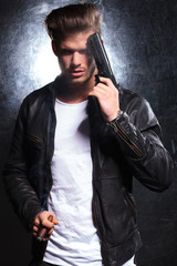 young killer with a big gun is smoking cigar