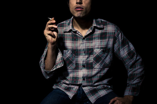 Man smoking cigarette in the dark