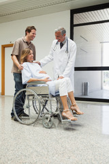 Doctor is talking to a pregnant patient in a wheelchair