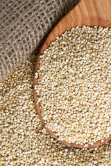 white quinoa on wooden background
