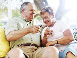 senior couple drinking wine outside on patio