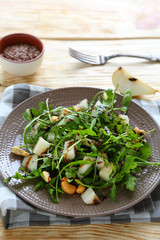 juicy fresh salad with arugula and pear