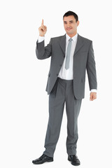 Businessman pointing upwards