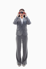 Surprised businesswoman looking through binoculars