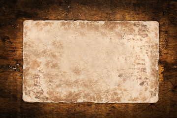 Damaged old paper sheet on a dark background