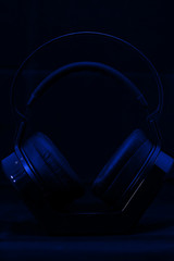 Fototapeta na wymiar Headphones on blue background