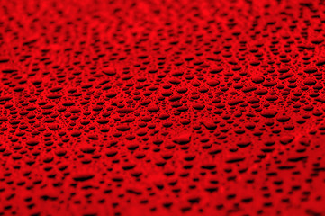 red water drops on water-repellent surface